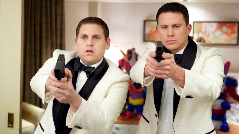 Jonah Hill and Channing Tatum hold guns