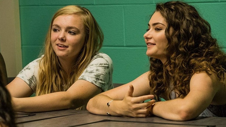 Elsie and her older friend Olivia chatting in the back of a class