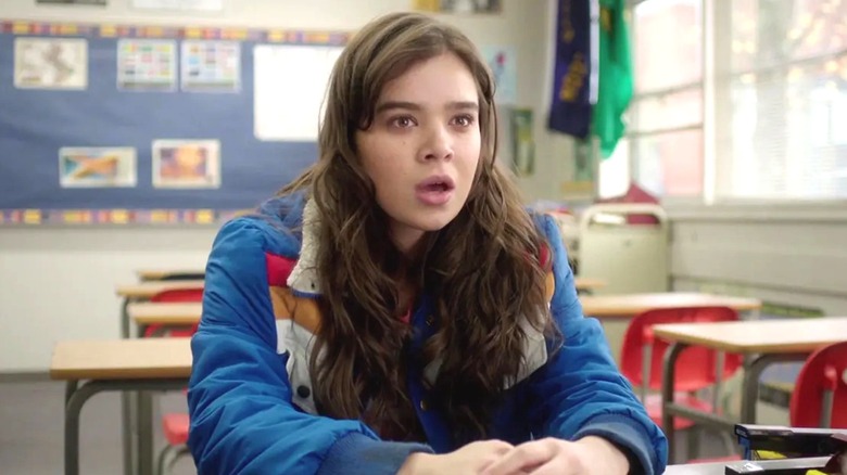 Nadine sitting at a desk in Mr. Bruner's empty classroom