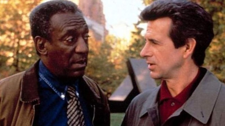 Cosby talks to his partner in the park