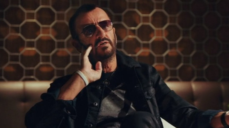 Ringo Starr talking on a couch