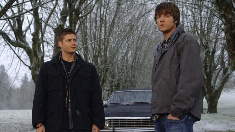 Dean and Sam stand in front of car