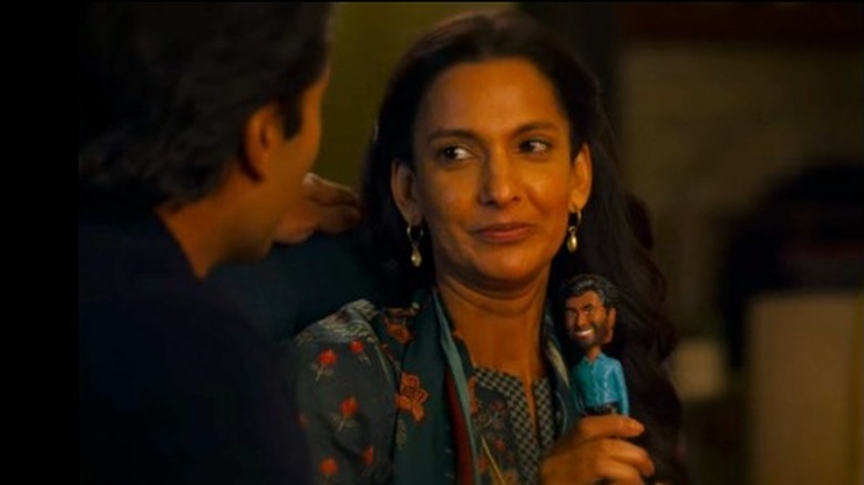 Nalini holds Mohan's bobblehead