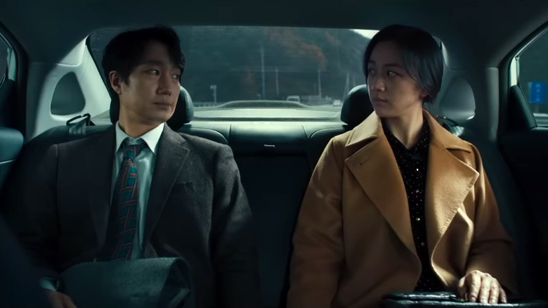 Park Hae-il and Tang Wei staring at each other in car