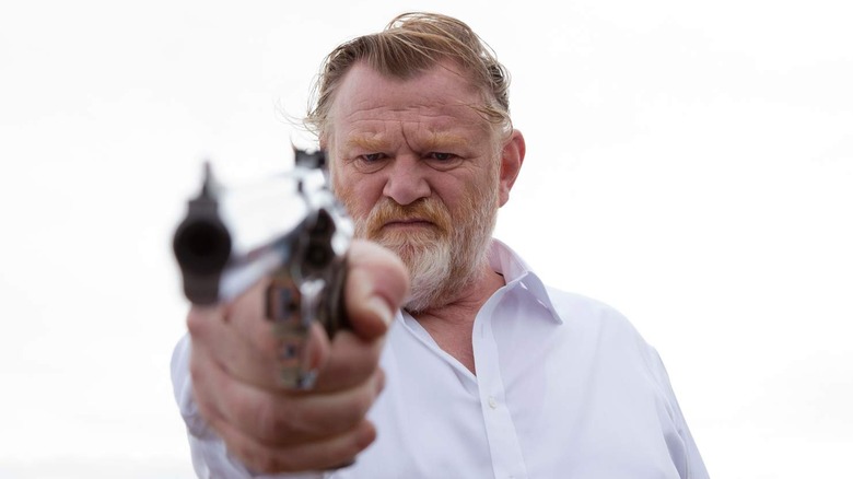 Father James pointing a revolver