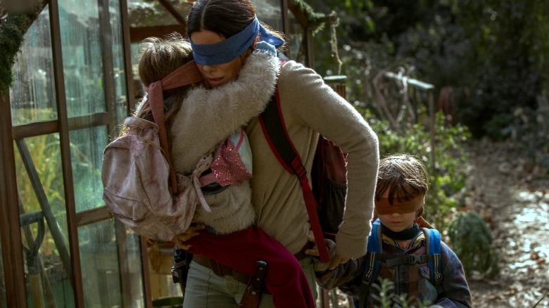 Malorie making her way through the landscape with Boy and Girl