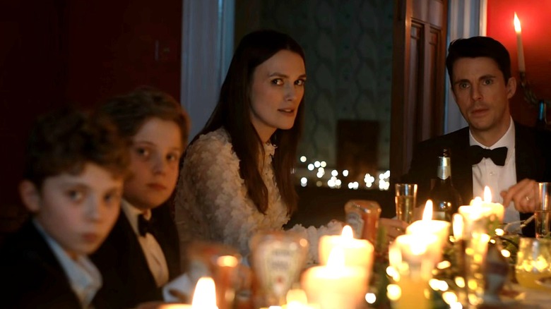 Nell, Simon, and two of their children at dinner in Silent Night