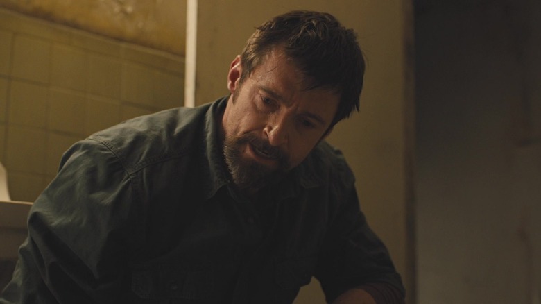 Keller Dover crouches in an abandoned building in "Prisoners" (2013)