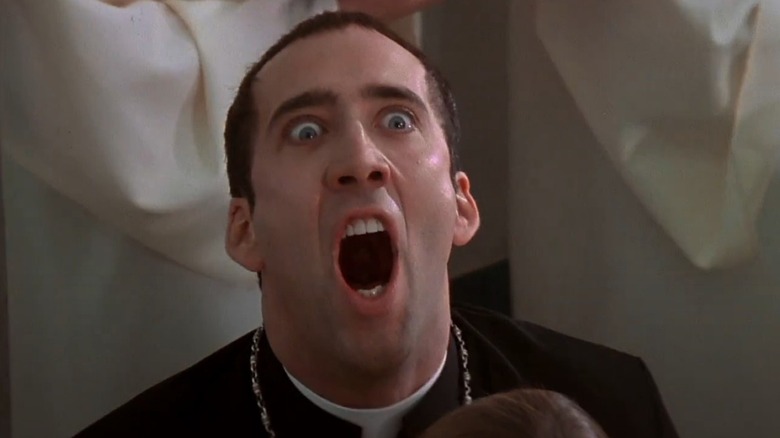 Castor Troy in priest outfit looking up and screaming