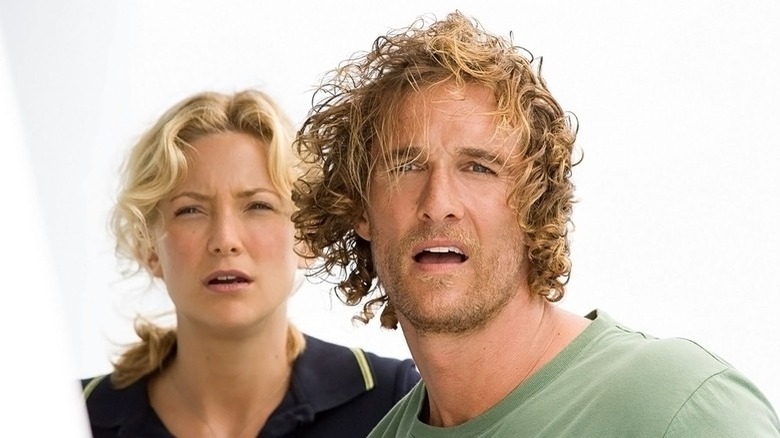 Kate Hudson and Matthew McConaughey squinting down at something 