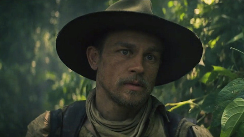 Charlie Hunnam with hat in jungle 