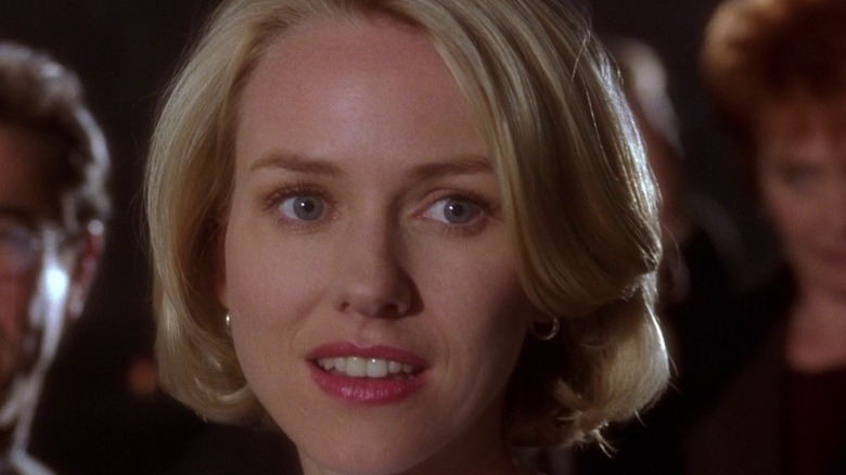 Naomi Watts looks to side half smile