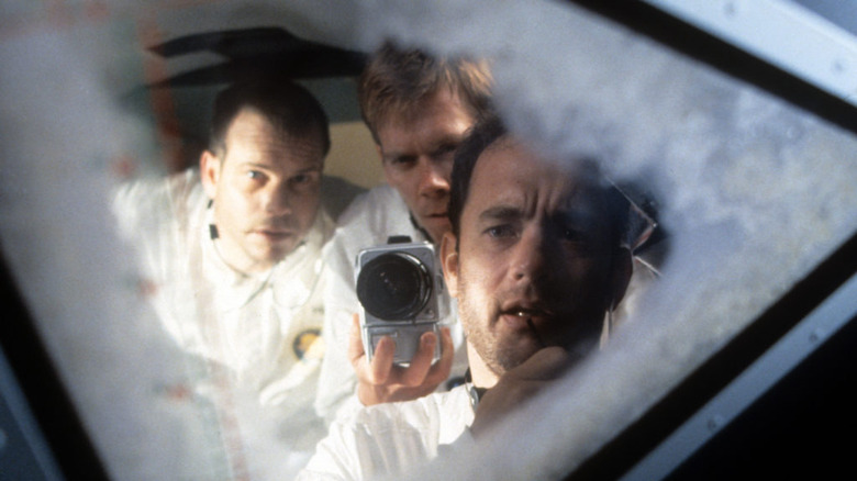 Bill Paxton, Kevin Bacon, and Ton Hanks look in Apollo 13
