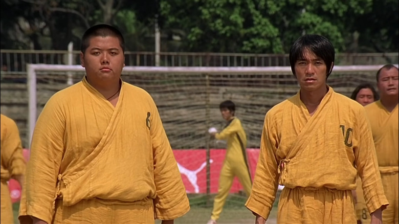 Men in yellow robes on soccer field 