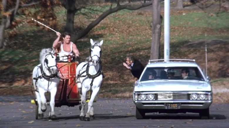 Arnold Schwarzenegger rides horse next to car