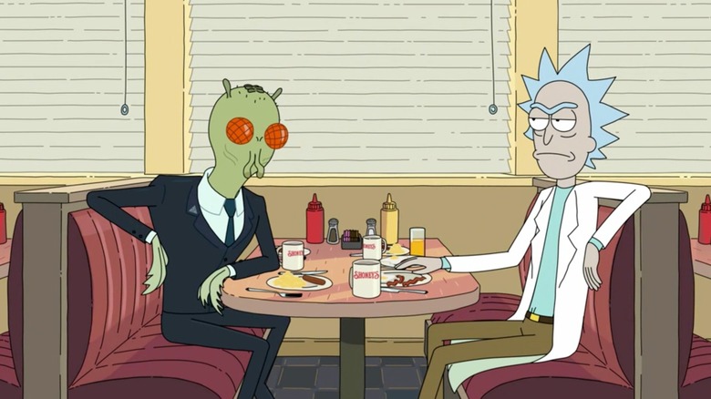 Rick sitting in a Shoneys across from an alien bureaucrat in "The Rickshank Rickdemption"