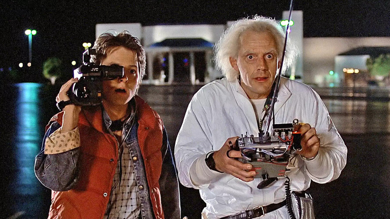 Marty looks through camera and Doc Brown holds control