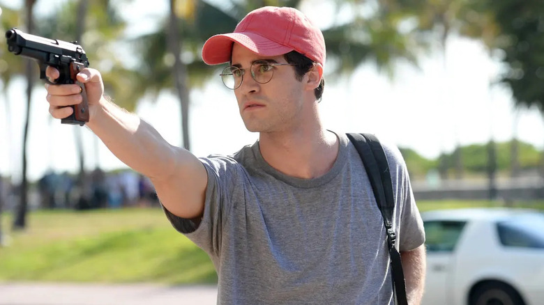 Darren Criss brandishing a gun