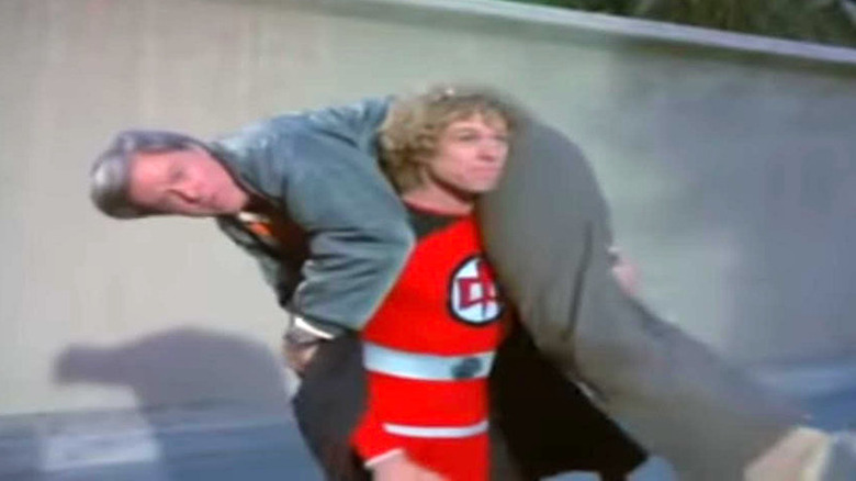 William Katt carrying a man