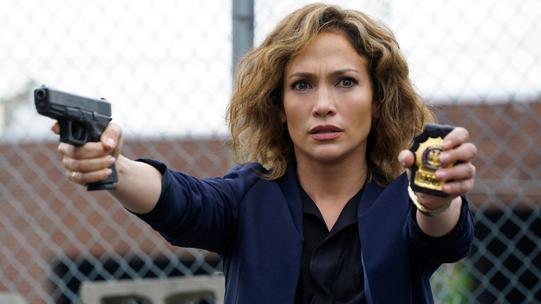 Jennifer Lopez with gun and badge