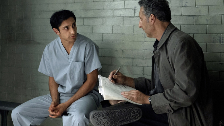 Naz and John talking in a cell