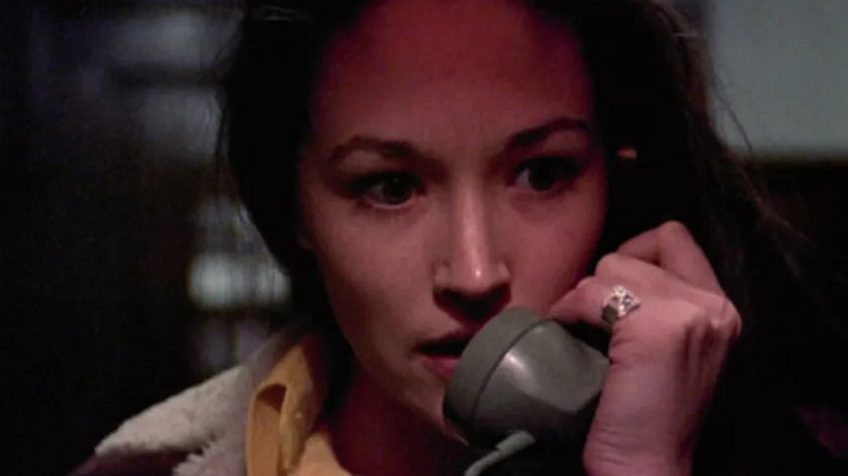 Olivia Hussey holds a phone receiver