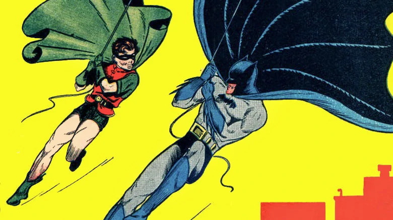 Batman and Robin swing above Gotham