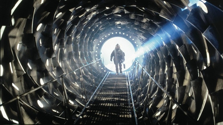 Astronaut walks through tunnel