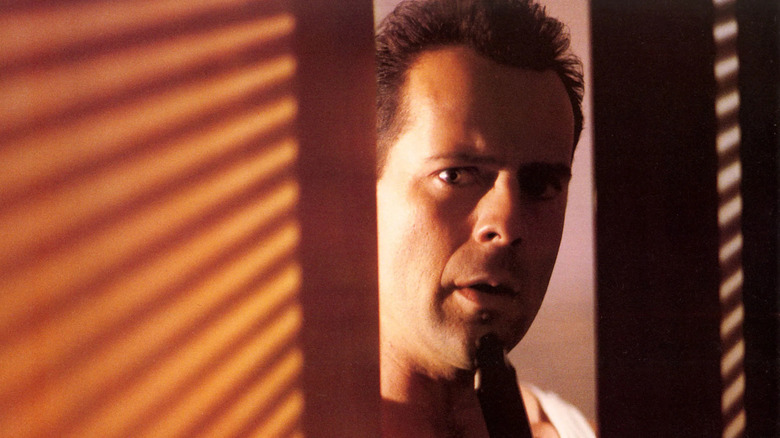 John McClane looks through doorway