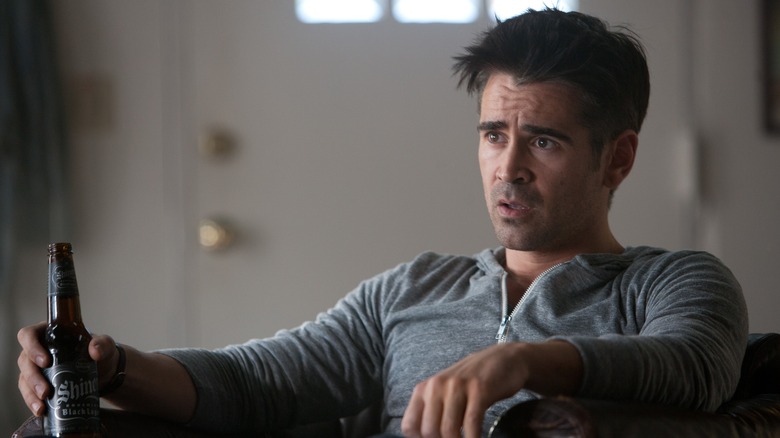 Colin Farrell holding a bottle of beer 