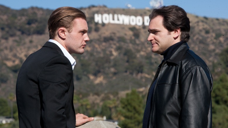 Michael Pittt and Michael Stuhlbarg in front of the Hollywood sign 