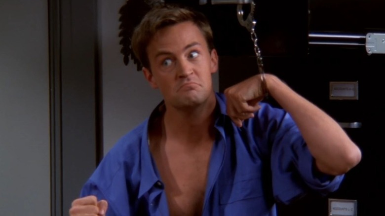 Chandler wearing handcuffs