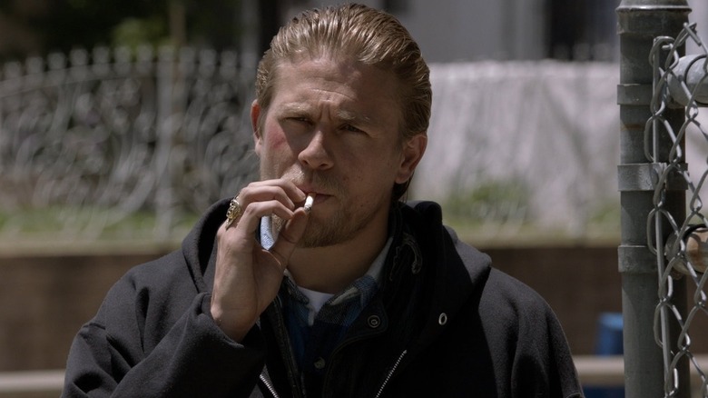 Jax smokes a cigarette