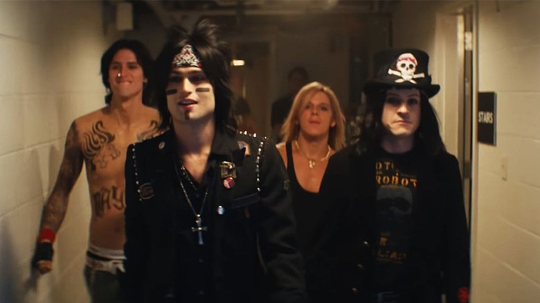 Motley Crue walk down a corridor