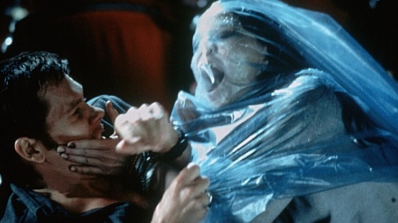 Woman in plastic grabs Kevin Bacon's face