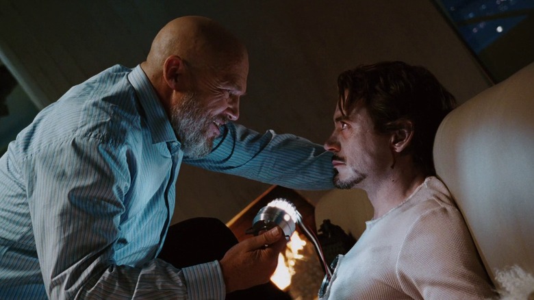 Obadiah Stane holding Tony's heart