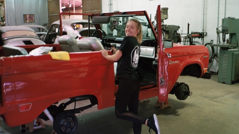 Sweeney posing with a 1969 Ford Bronco