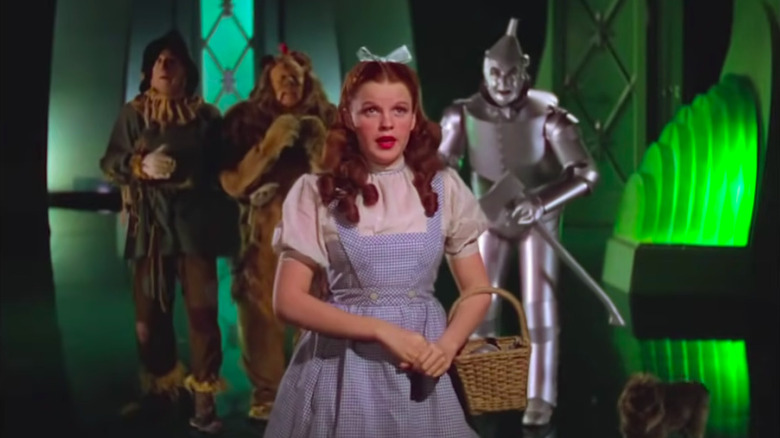 Dorothy with the Scarecrow, Lion, and Tin Woodsman in back of her