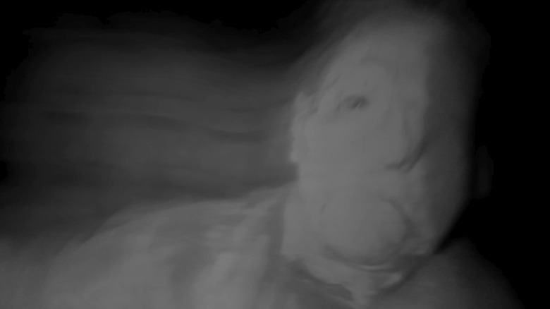 A face appearing in the dark