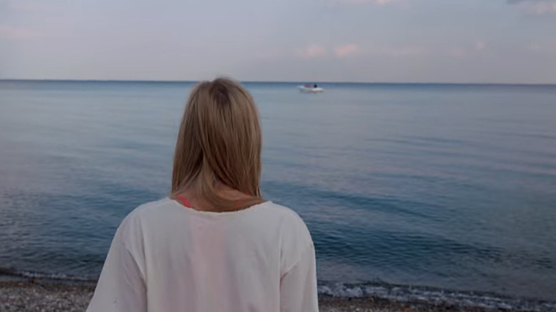 Jay staring at a boat on the water