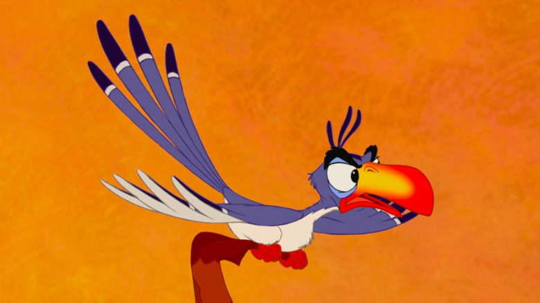Zazu perched on a brach with his wings out