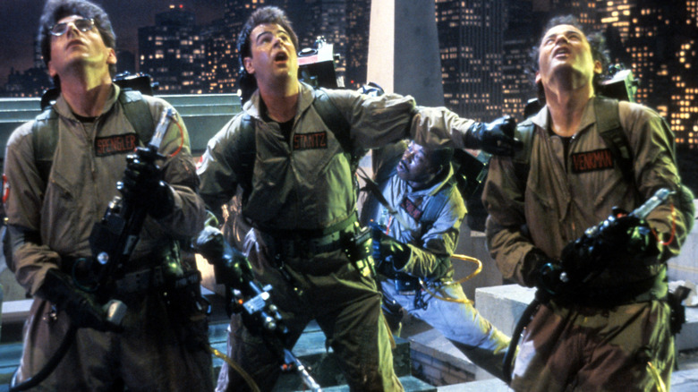 Egon, Ray, Winston, and Peter look upwards in "Ghostbusters" (1984)