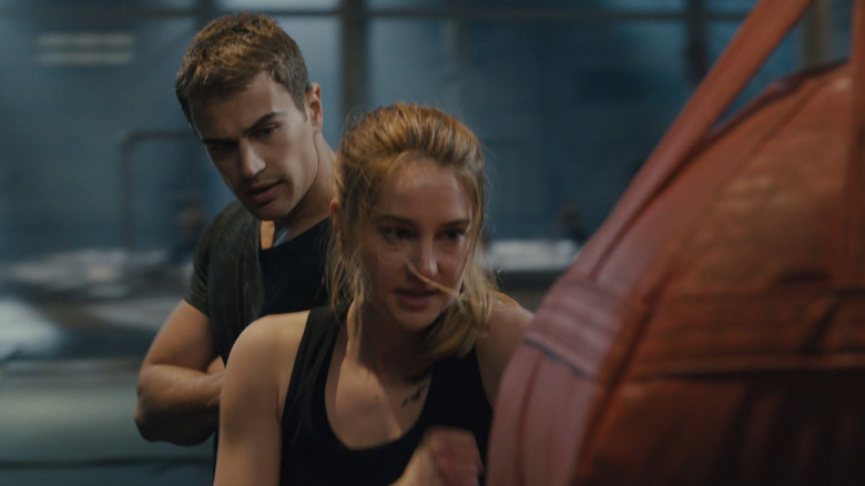 Tris trains as Four looks on in Divergent