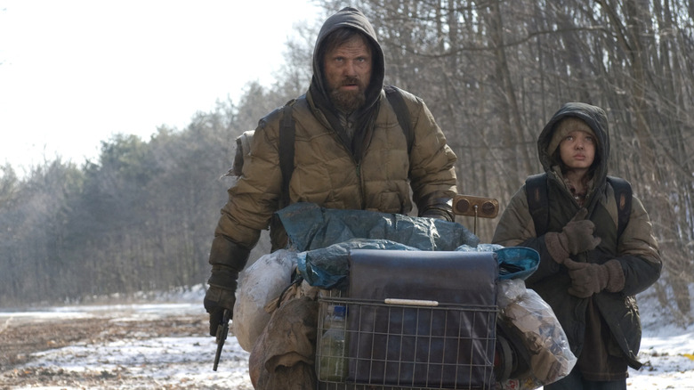 The Man and the Boy walk across the road in "The Road" (2009)