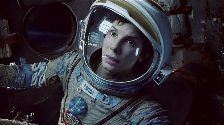 Sandra Bullock sitting in a space capsule