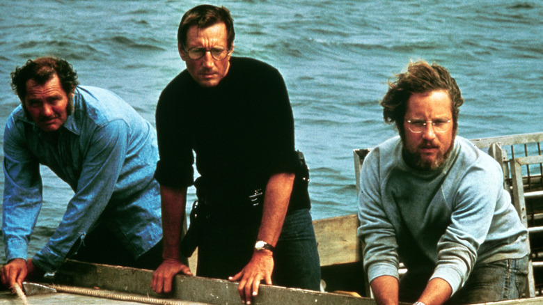 The crew standing at the stern of a boat