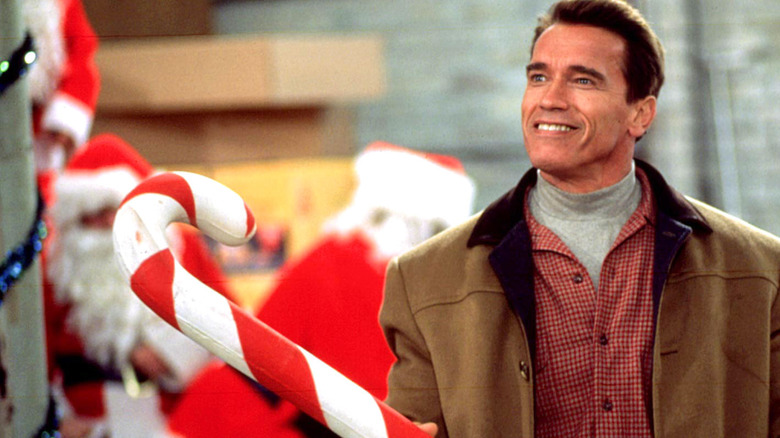 Arnold Schwarzenegger holding candy cane