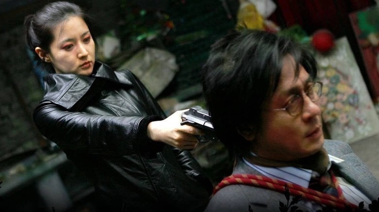 Geum-ja holds gun to man's head