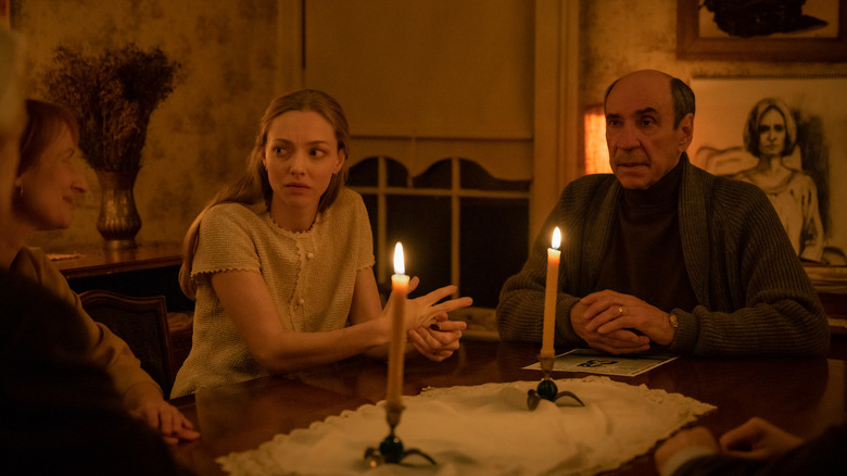 Worried Catherine sits at table with man 