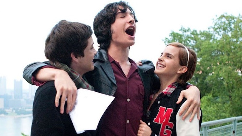 Miller celebrating with Logan Lerman and Emma Watson